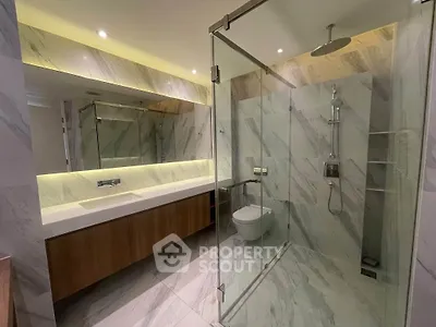 Luxurious modern bathroom with glass shower and elegant marble finishes