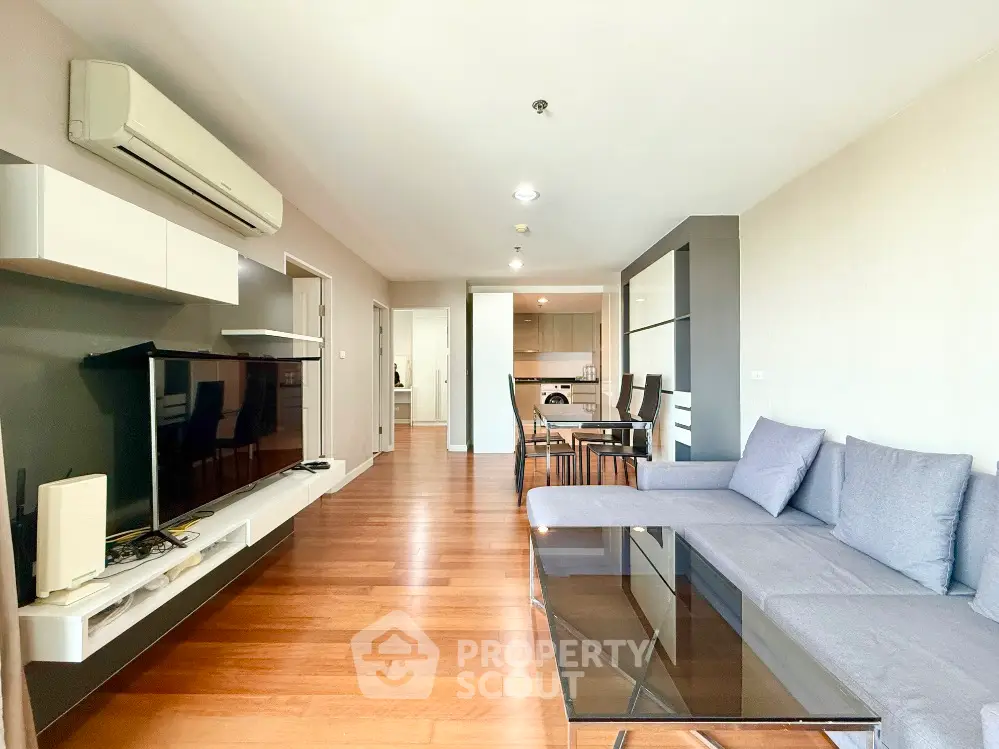 Spacious modern living room with sleek furniture and open kitchen layout