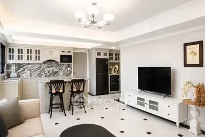 Elegant open-layout kitchen and living area with modern appliances and stylish decor.