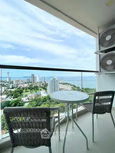 Stunning balcony view overlooking cityscape and ocean, perfect for relaxation.