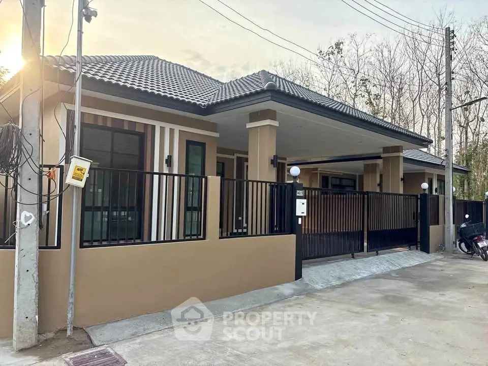 Modern single-story house with sleek design and gated entrance in a serene neighborhood.