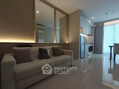 Modern living room with sleek kitchen and stylish decor in open layout apartment.