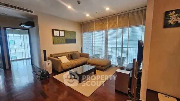 Spacious living room with modern decor and large windows for natural light.
