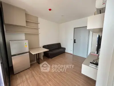 Modern living room with sleek furniture and wooden flooring in a stylish apartment.