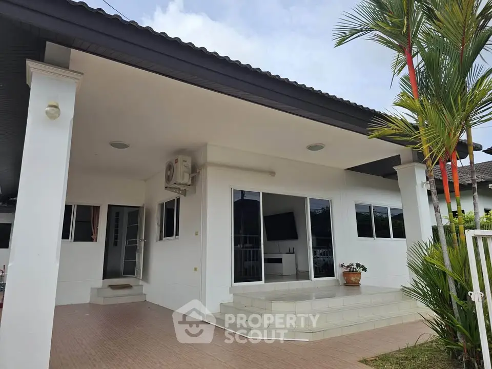 Charming single-story home with spacious front porch and modern exterior design.