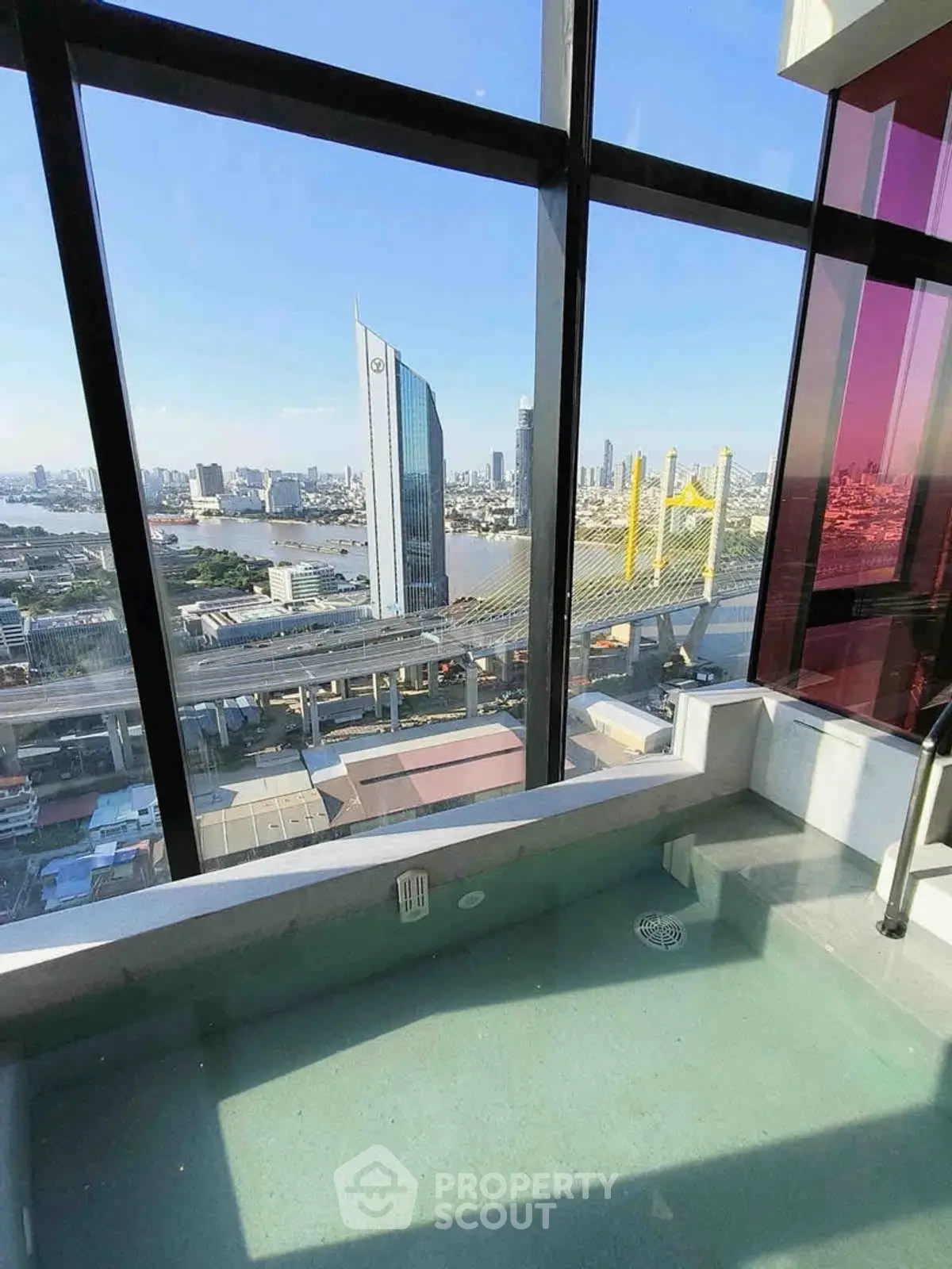 Stunning city view from high-rise building with floor-to-ceiling windows and private pool.