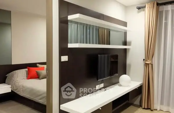 Modern bedroom with sleek TV setup and stylish decor