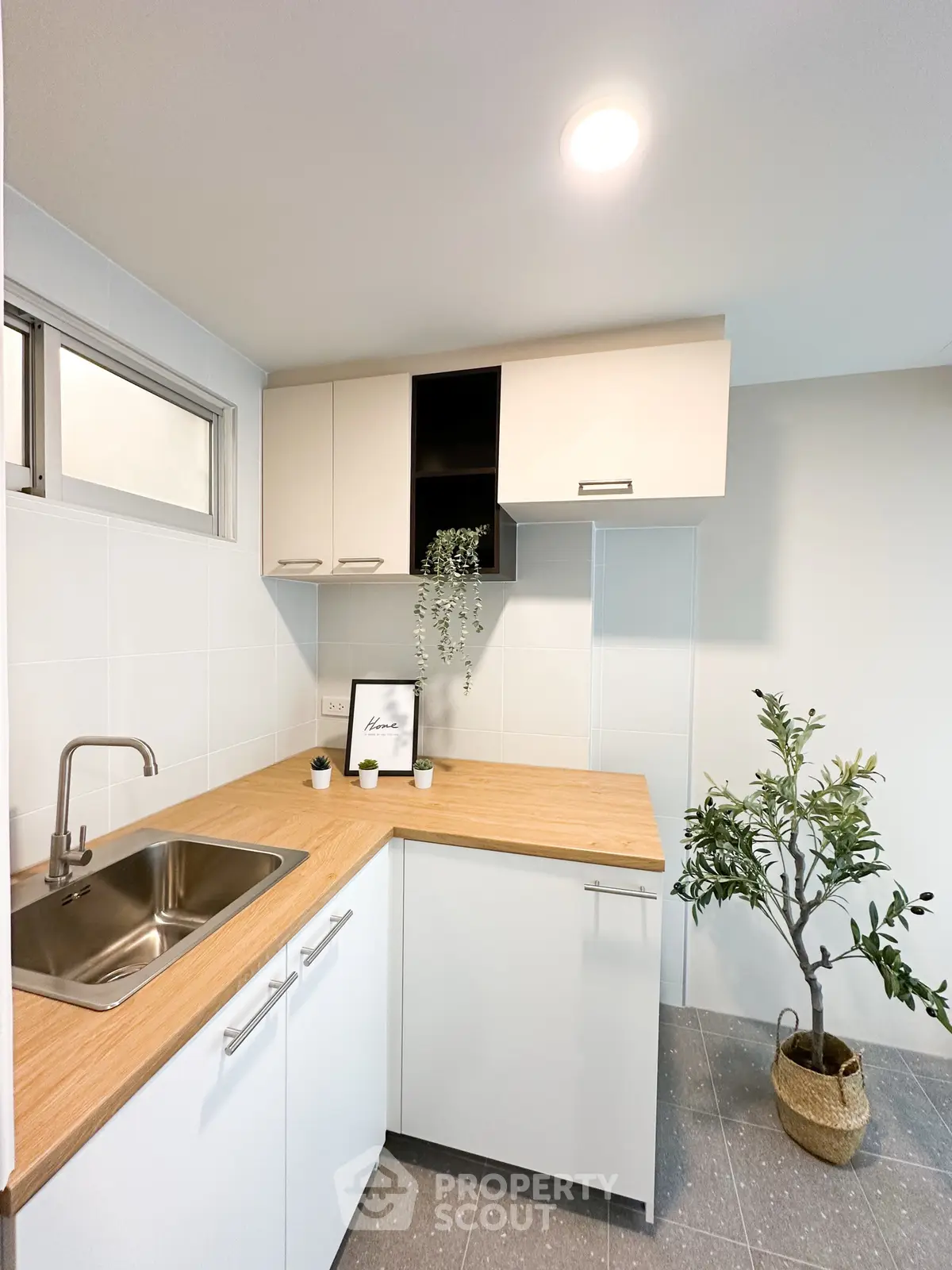 Modern kitchen with sleek cabinetry and stylish decor in a contemporary apartment.