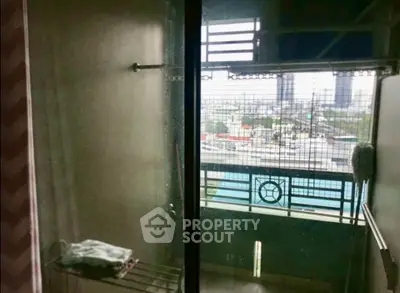Urban apartment balcony with city view and glass railing, ideal for modern living.