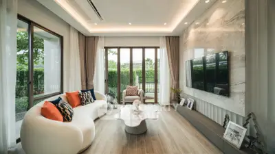 Luxurious modern living room with elegant decor and large windows overlooking a lush garden.