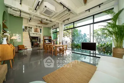 Spacious modern living room with large windows and garden view
