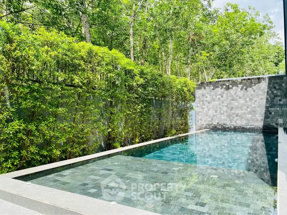 Luxurious private pool surrounded by lush greenery, perfect for relaxation and leisure.