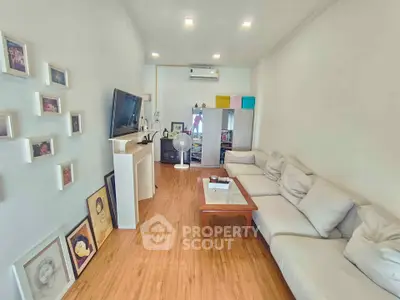 Spacious living room with modern decor and cozy seating area, perfect for relaxation and entertainment.