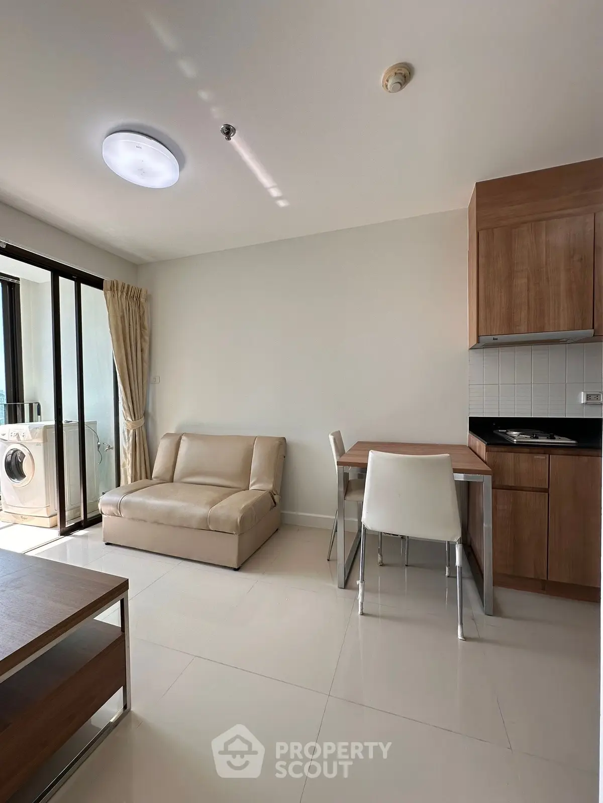 Modern living room with open kitchen and balcony access