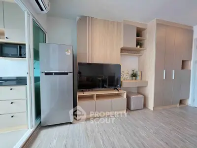 Modern living room with sleek cabinetry and integrated kitchen appliances
