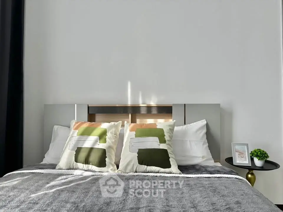 Modern bedroom with stylish decor and cozy bedding, perfect for relaxation and comfort.
