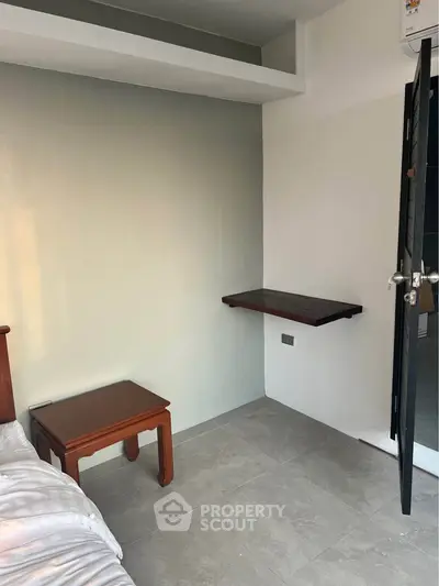 Minimalist bedroom with wooden furniture and wall-mounted desk
