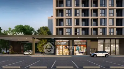 Modern building exterior with retail spaces and parking area