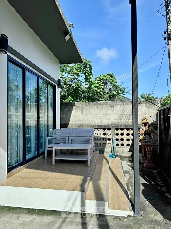 Charming outdoor patio with seating area and modern design, perfect for relaxation.