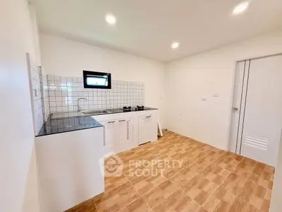 Modern kitchen with sleek design and tiled backsplash in a bright, spacious interior.