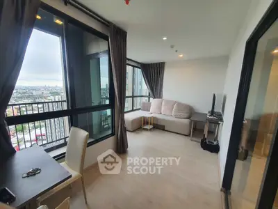 Modern living room with large windows and city view, featuring cozy seating and sleek decor.