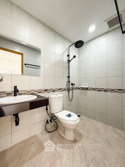 Modern bathroom with sleek fixtures and spacious shower area