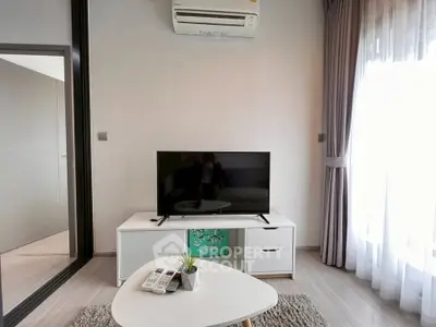 Modern living room with sleek TV unit and air conditioning, perfect for cozy relaxation.