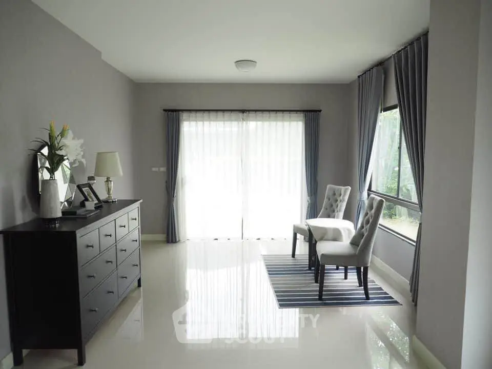 Spacious living room with elegant decor and large windows for natural light.