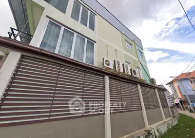 Modern building exterior with multiple air conditioning units and sleek design.