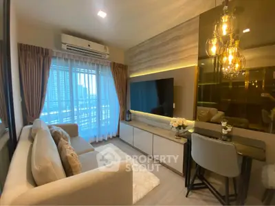 Modern living room with elegant decor, large TV, and city view from window.