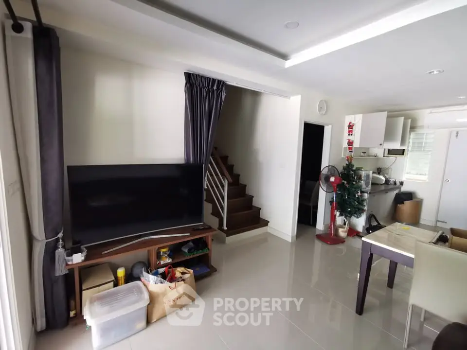 Spacious living room with modern decor and open kitchen layout