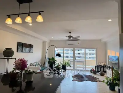 Spacious living room with modern decor and large windows offering ample natural light.