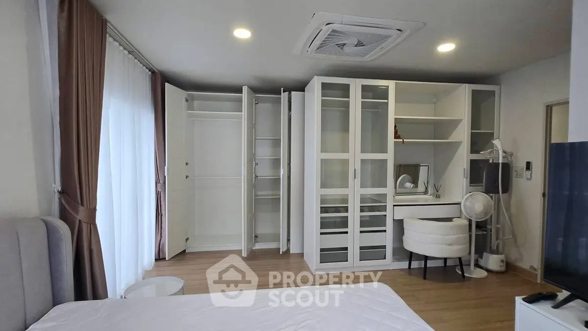 Modern bedroom with open closet and stylish furniture