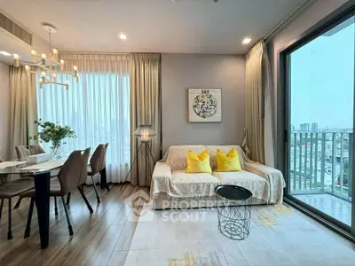 Stylish living room with city view, modern decor, and elegant dining area in a high-rise apartment.