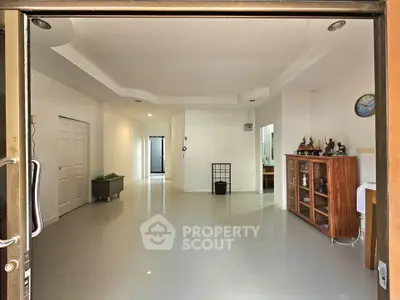 Spacious modern living room with elegant decor and ample natural light.
