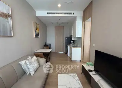 Modern living room with stylish decor and compact kitchen area, perfect for urban living.