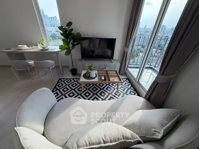 Modern living room with city view, stylish furniture, and natural light.