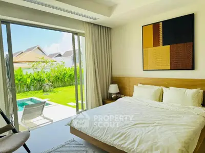 Luxurious bedroom with pool view and modern decor in a serene setting.
