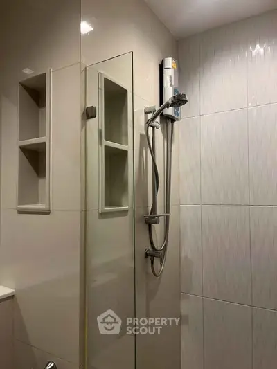 Modern bathroom with sleek shower design and built-in shelving