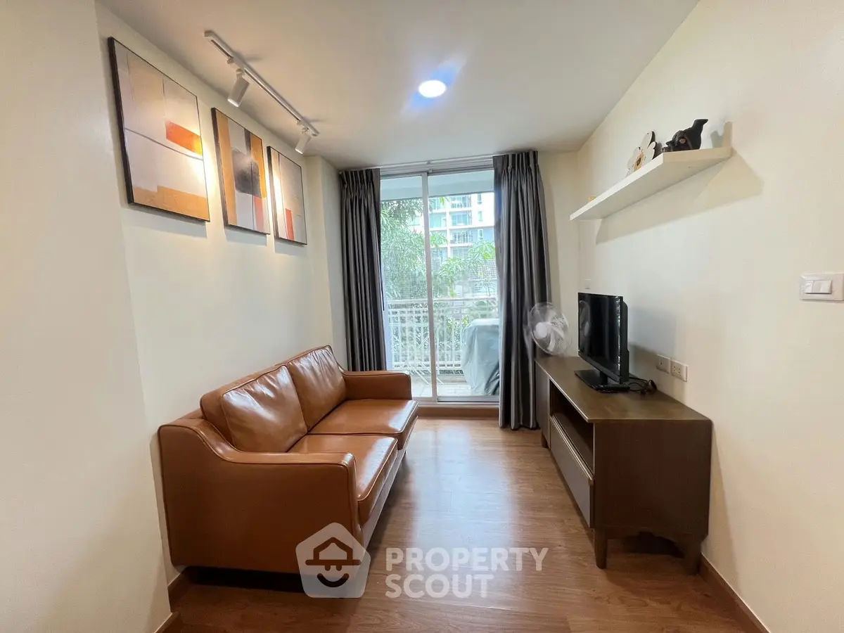 Cozy living room with modern decor and balcony view in urban apartment