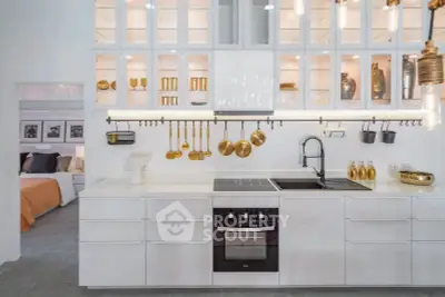 Modern kitchen with sleek white cabinetry and gold accents