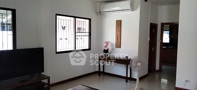 Spacious living room with modern decor and air conditioning in a stylish home.