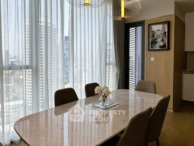 Elegant dining area with marble table and city view, featuring modern lighting and decor.