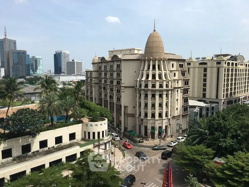Stunning aerial view of a grand architectural building in a bustling cityscape, showcasing urban elegance and luxury.