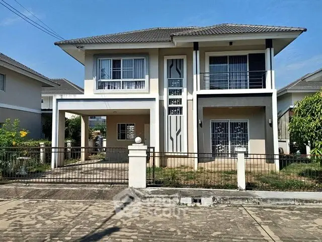 Modern two-story house with a spacious driveway and stylish facade in a suburban neighborhood.