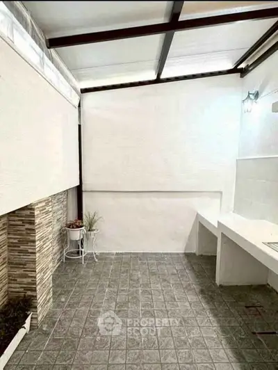 Charming outdoor patio with tiled flooring and modern design, perfect for relaxation and entertaining.