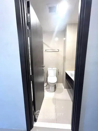 Modern bathroom with sleek design and contemporary fixtures in a real estate property.