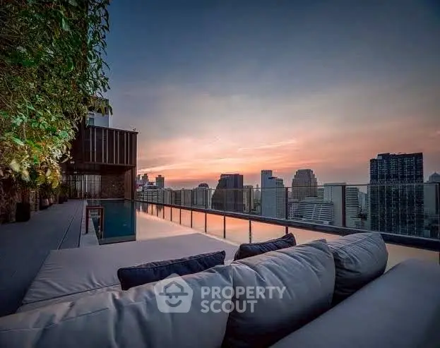 Luxurious rooftop terrace with stunning city skyline view at sunset.