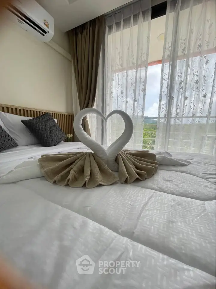 Luxurious bedroom with elegant decor and scenic balcony view, perfect for relaxation and comfort.