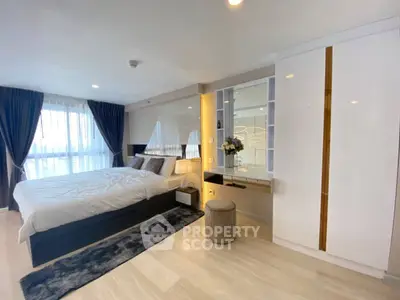 Spacious modern bedroom with large windows and elegant decor